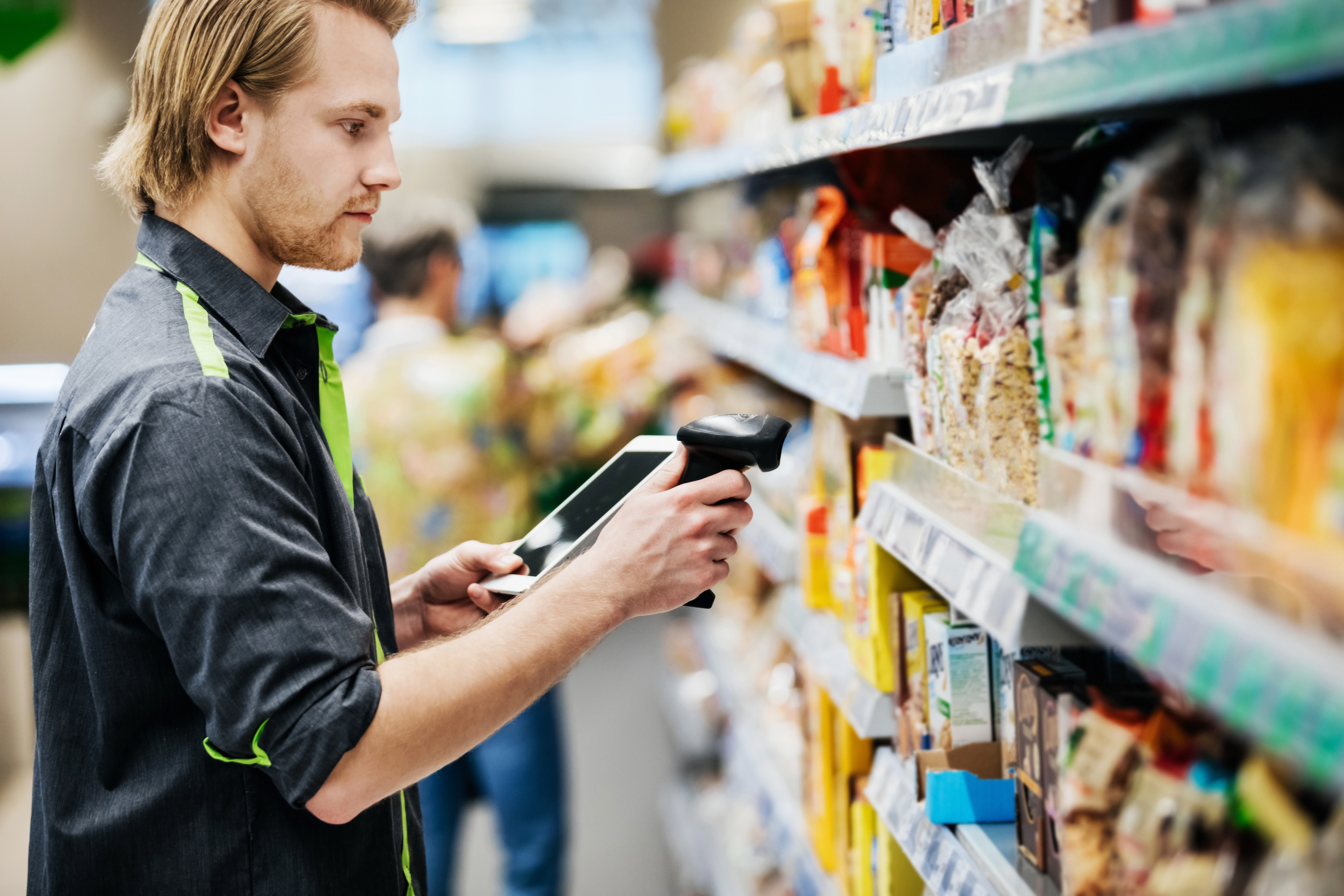 Market employee. Supermarket worker. Scanning food.