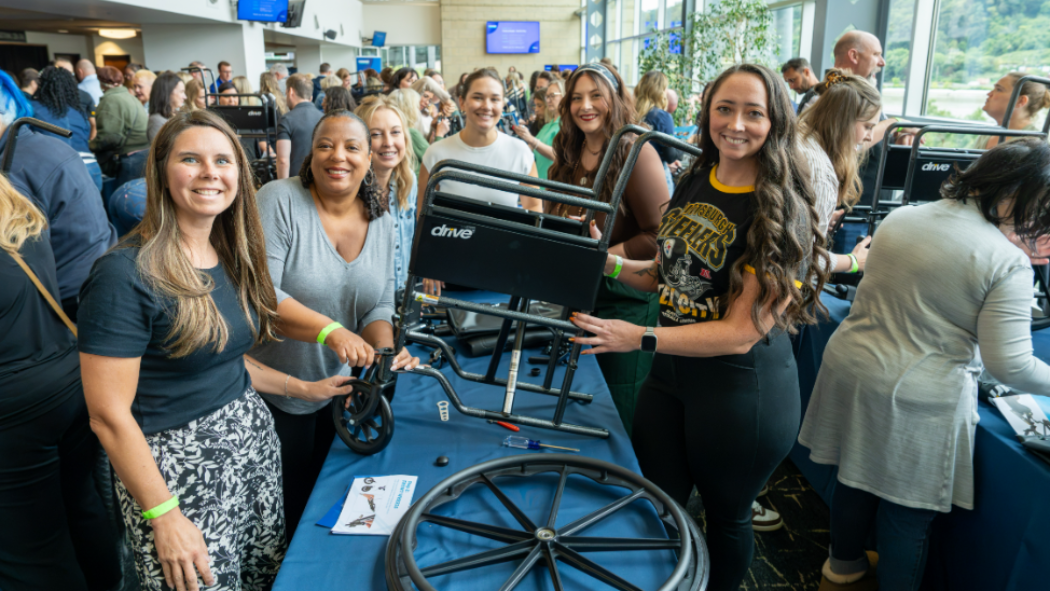 Employees building wheelchairs