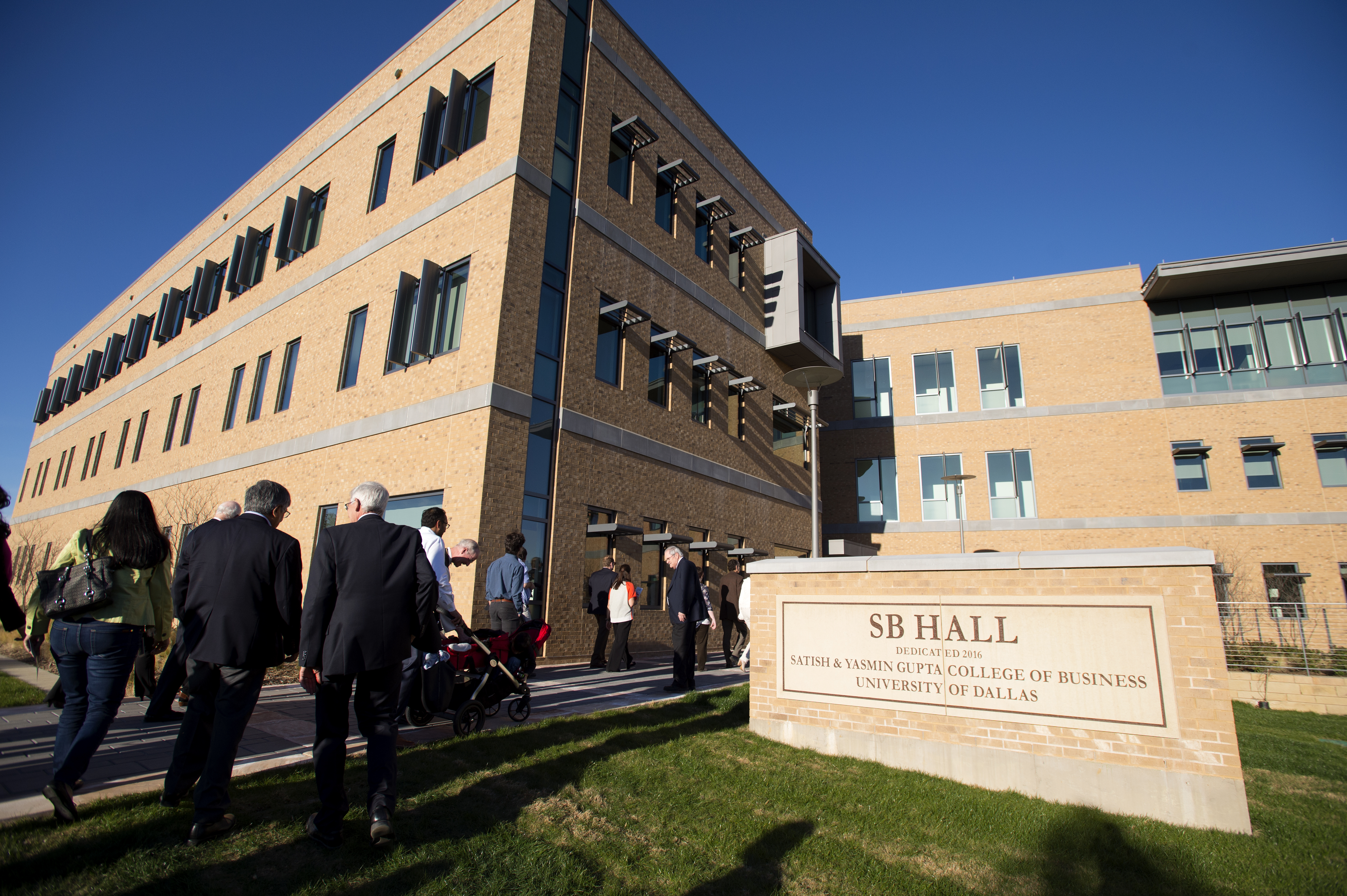 People walking into SB Hall on the University of Dallas campus