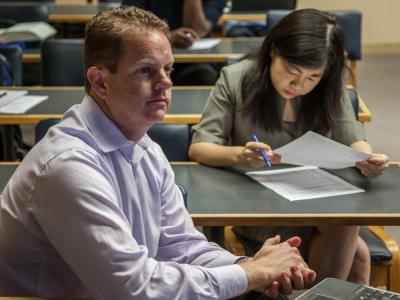 Finance professor Jenny Gu and student in classroom