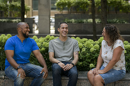 A group of three warriors sitting outside talking.